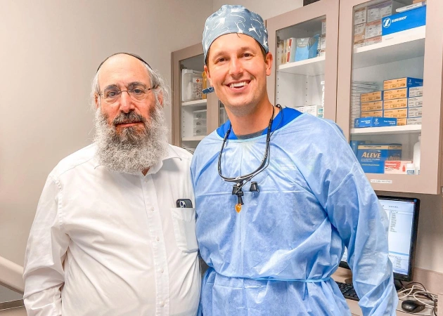 Dentist and patient smiling together in a dental office, showcasing personalized care at Warwick Dental, Oklahoma City.