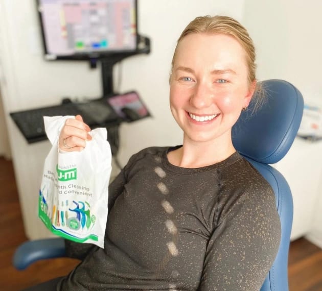 Happy patient after receiving Invisalign at Warwick Dental, Oklahoma City