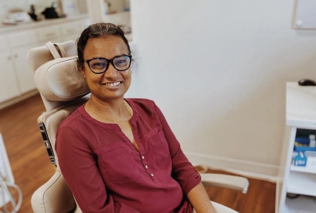 Smiling woman in dental chair after routine checkup at Warwick Dental, Oklahoma City, showcasing positive dental experience and care.