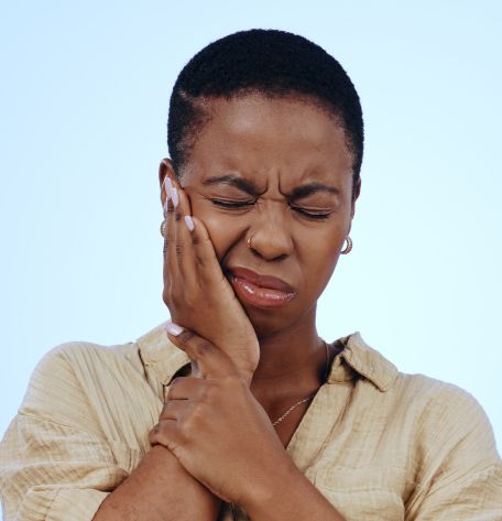 Woman with tooth pain, cared for by Warwick Dental team in Oklahoma City